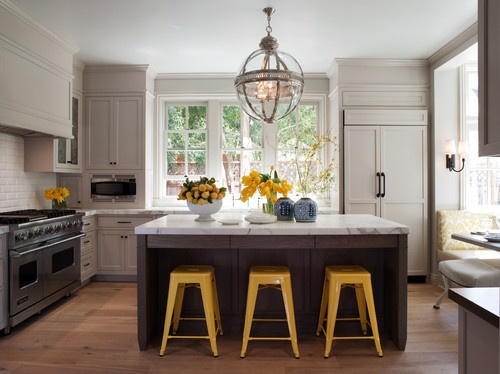 Kitchen with yellow accents, yellow stools, lemons, flowers