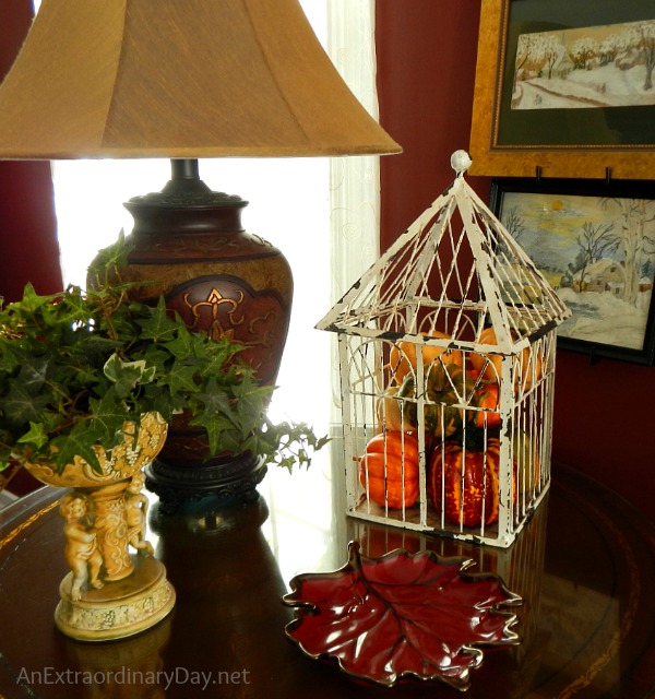 A decorated side table and tips for dressing a living room for fall.