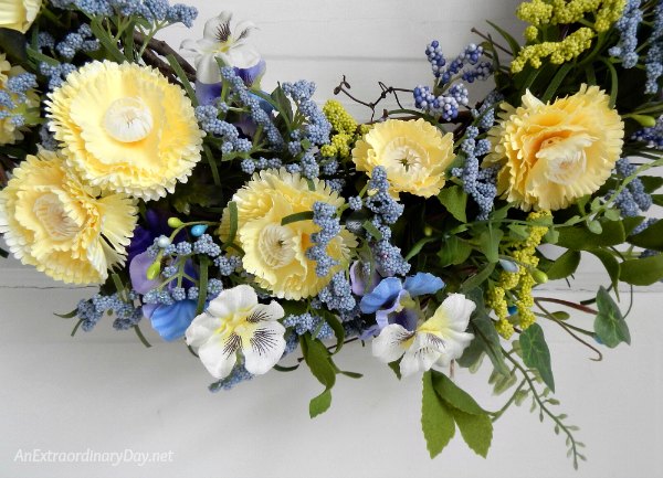 Butter yellow and pretty blues help make a pretty wreath to decorate the front door