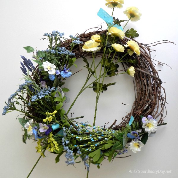 Place flowers and greens around the wreath to get a feel for it before beginning 