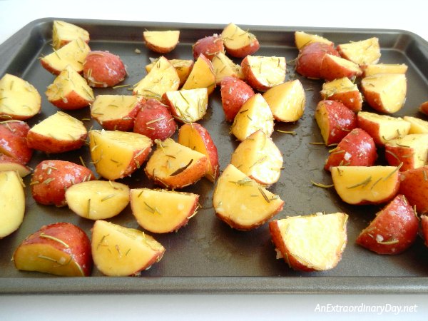 Place seasoned potatoes on baking sheet for roasting 