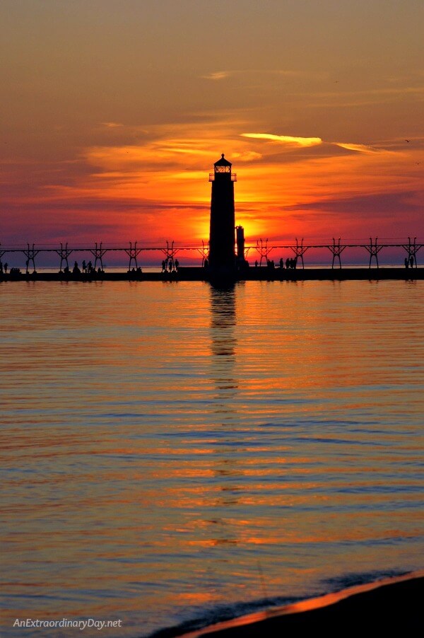 Grand Haven Lighthouse at Sunset - Be encouraged with this inspirational meditation on faith in challenging times at AnExtraordinaryDay.net