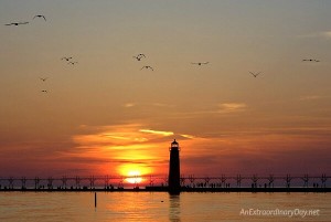 Learning to walk in faith - a devotional mediation on Hebrews 11 at AnExtraordinaryDay.net Sunset over the pier and lighthouse on Lake Michigan