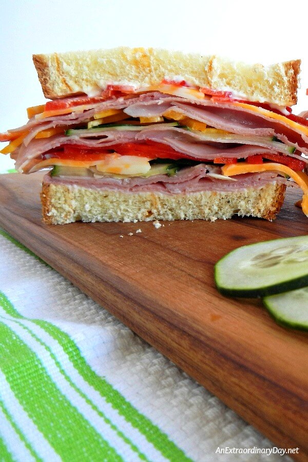 Ham and cheese and veggies between two slices of 3 cheese bread and mayo... It's pure heaven. A super simple to make summer stacked sandwich. Stop drooling and Click for the recipe at AnExtraordinaryDay.net
