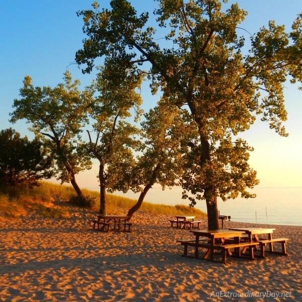 Sunset at the Lake Michigan Lakeshore wth the empty picnic tables at season's end glowing in the setting rays of the sun - AnExtraordinaryDay.net