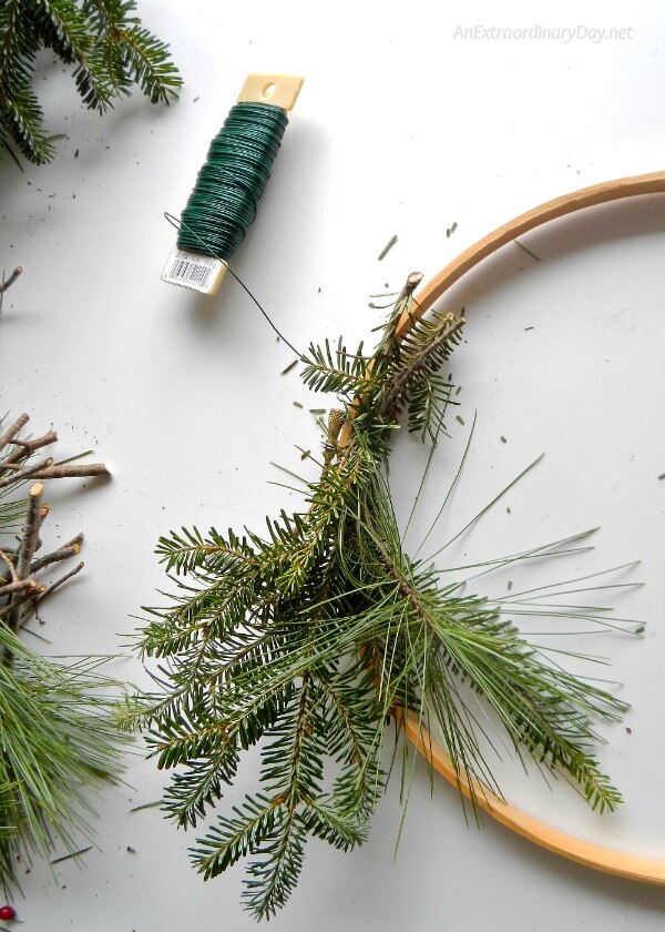 Gather bunches of evergreen and tie them together with your paddle wire - AnExtraordinaryDay.net