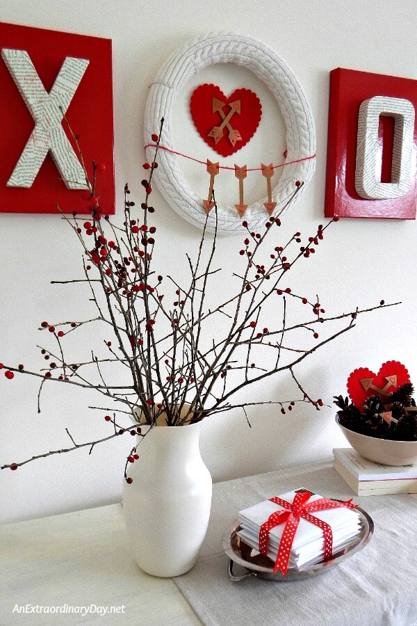 Dried twigs of winterberry provide visual interest to this Valentine vignette