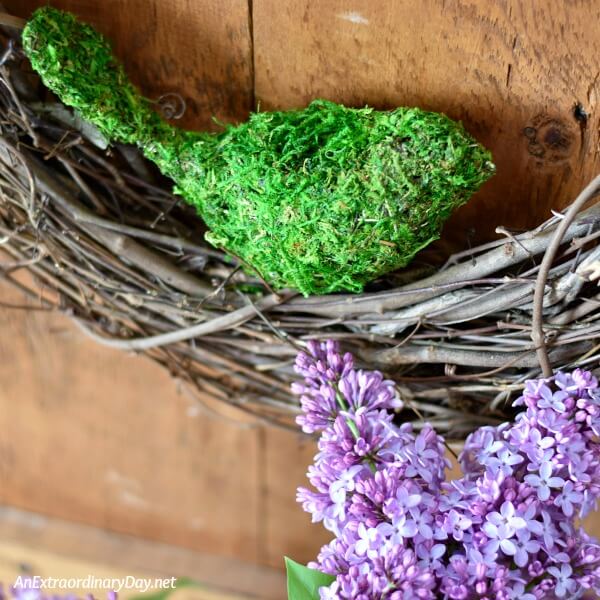 Mossy bird adds to this beautiful lilac vignette