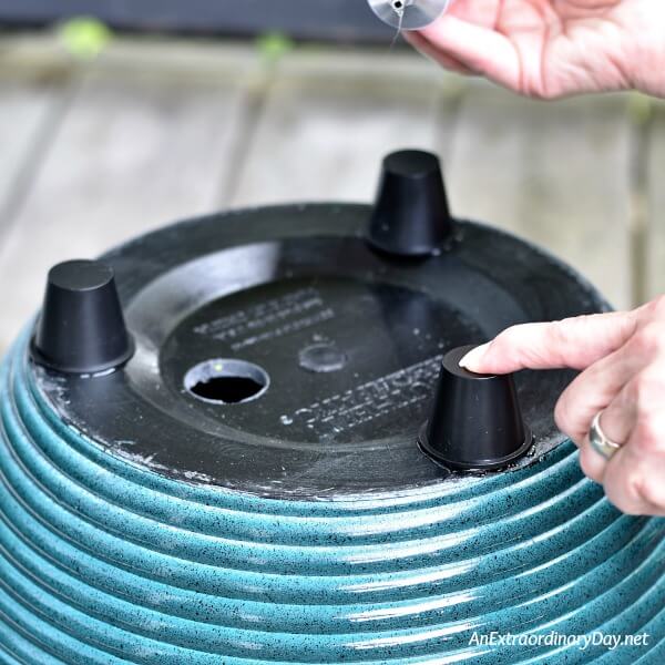 Attach feet to the bottom of the container fountain