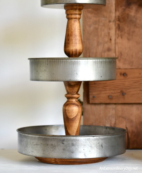 Stained candlesticks and vintage style cake pans make a great fixer upper style 3-tiered tray