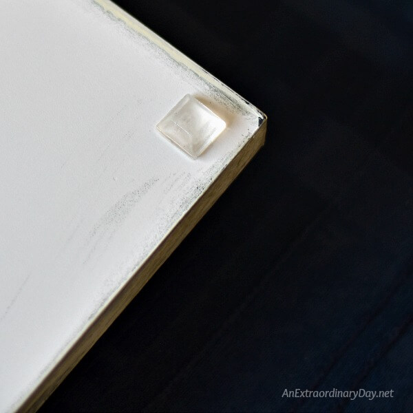 Adding plastic bumpers to the bottom of the modern farmhouse tray coffee table