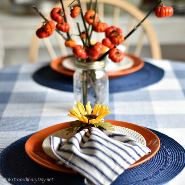 Embrace navy and white for Fall and Thanksgiving with this simple table setting on a large dark blue and white checked table cloth 