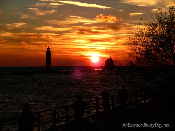 Lighthouse silhouetted against a stunning sunset on Lake Michigan 