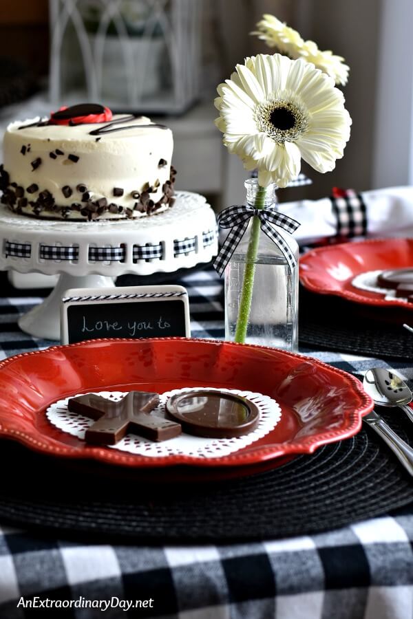 Black and white checked table with red plates for Valentine's Day - AnExtraordinaryDay.net