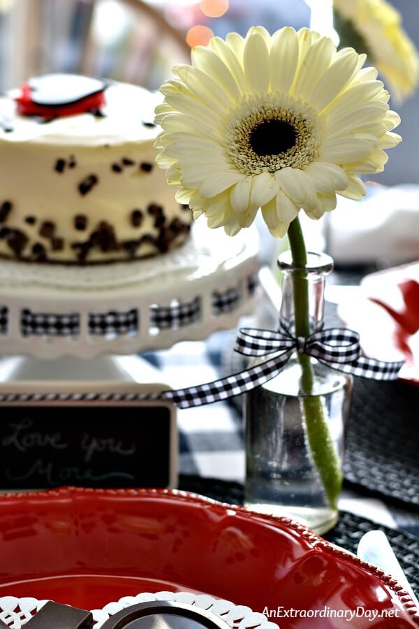 Cream colored Gerbera Daisy in Vintage Bottle Makes a Personal Bud Vase on this Simple Valentine Table - AnExtraordinaryDay.net
