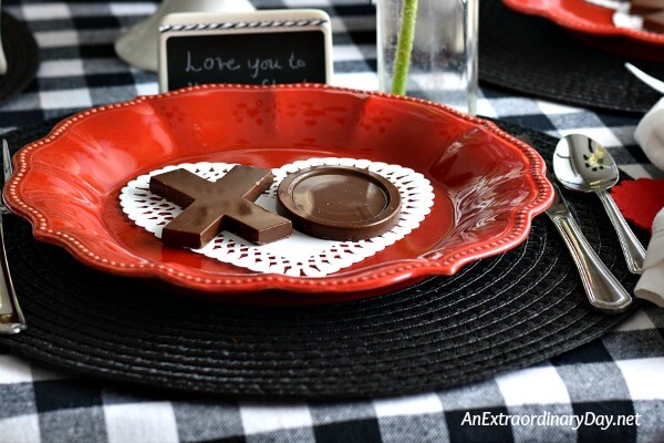 Simple table setting of red plate + black placemat + black and white check tablecloth for Valentine's Day - AnExtraordinaryDay.net