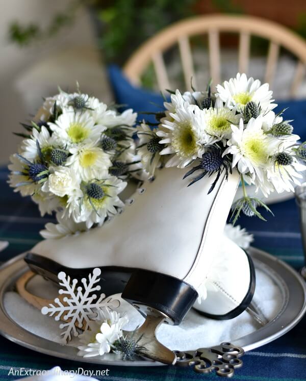 Stunning Winter Centerpiece of Ladies Figure Skates and Pretty White and Blue Flowers - Perfect for a Skating Party or Olympics Celebration - AnExtraordinaryDay.net