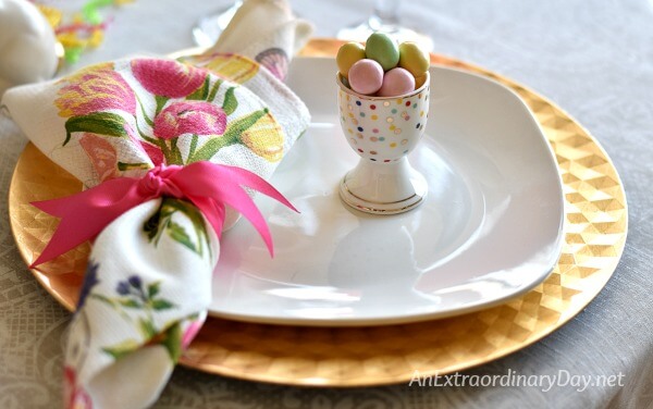 Gold chargers topped with creamy white plate a spring napkin and polka dot egg cup - AnExtraordinaryDay.net