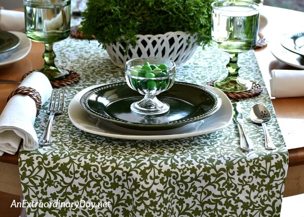 Green and white table runner with moss green and white dishes for this St. Patrick's Day table setting - AnExtraordinaryDay.net
