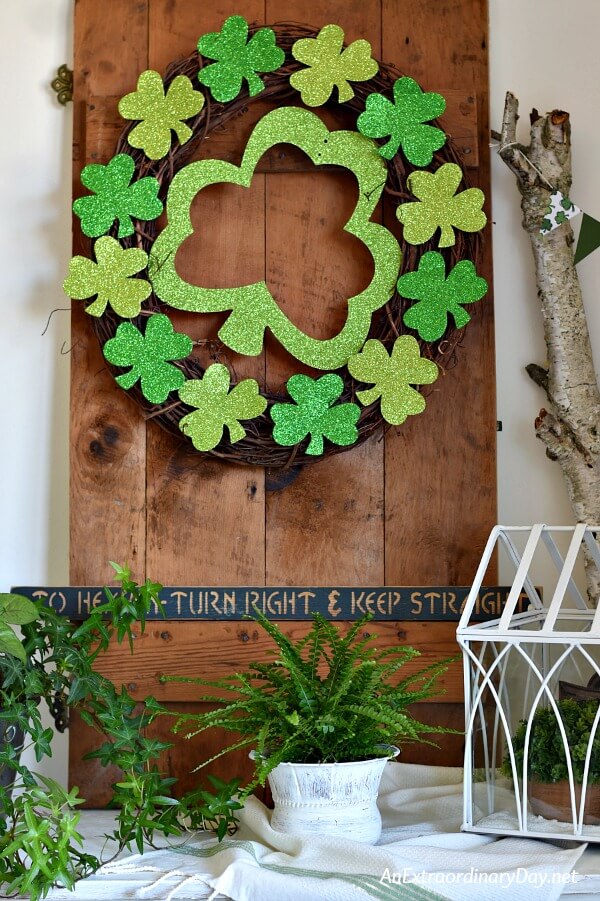  Sparkly St. Patrick's Day Wreath on Rustic Wooden Door on Console Table - AnExtraordinaryDay.net