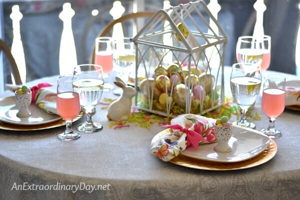 White and Gold Easter table set for dinner with an egg filled greenhouse centerpiece - AnExtraordinaryDay.net