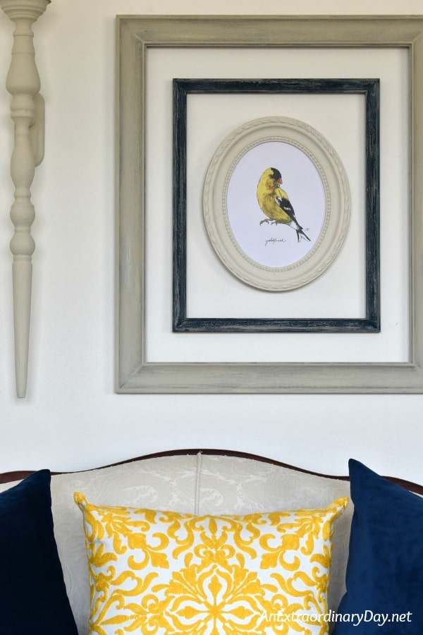 Spring Home Decor with Goldfinch Print framed with yellow pillow below - AnExtraordinaryDay.net