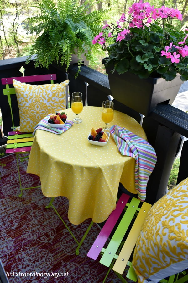 Small Space Summer Living Outdoor Dining Area with Yellow Tablecloth - AnExtraordinaryDay.net