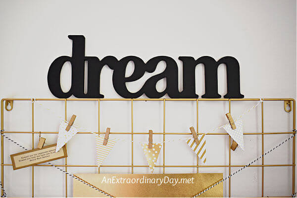 The word "dream" hangs on the wall of a home office to inspire.