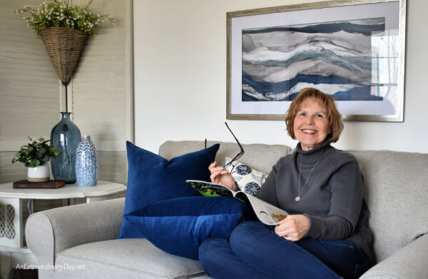 Author sitting on her new loveseat - AnExtraordinaryDay.net