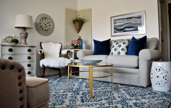 Gray and dark blue apartment living room with sofa + rug + coffee table